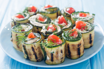 Zucchini rolls with cream cheese , tomatoes and dill