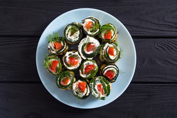 Zucchini rolls with cream cheese , tomatoes and dill
