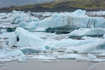 Floating icebergs melting in Fjallsarlon glacier lake, Iceland