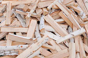 The concept of wood. Firewood chop. Natural raw material. The firewood is piled in a mess. Natural texture.