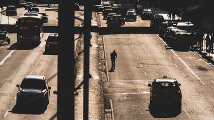 Skateboarder and cars on the road