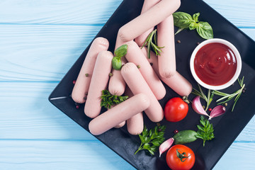 Raw beef sausages with pepper , herbs and ketchup