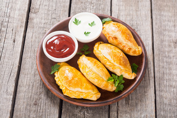 Latin American baked beef empanadas with sauce