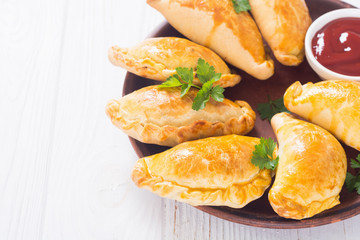 Latin American baked beef empanadas with sauce