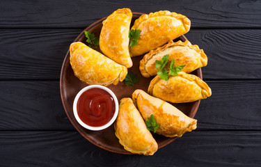 Latin American baked beef empanadas with sauce