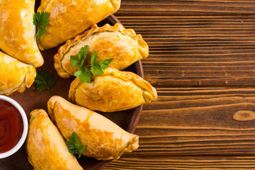 Latin American baked beef empanadas with sauce