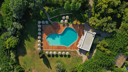 Fototapeta na wymiar Aerial top view photo of tropical sandy paradise beach with pool facilities in exotic island