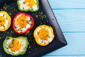 Yellow , red and green pepper with fried eggs