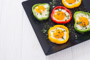 Yellow , red and green pepper with fried eggs