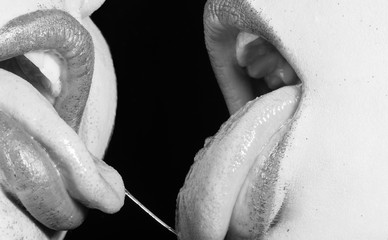 Erotic lesbian kiss. Two girls together close up. Female mouth with tongues. Black and white lipstick. Close relations. Sexy kiss. Woman lesbian concept. Lips and mouth. - 272316753