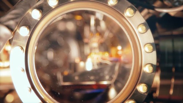 Close up view of a lens in a piece of scientific equipment found in a university laboratory facility. Modern equipment provides the best hands on education for students.