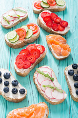 Variation of toast with fruit , vegetable and salmon