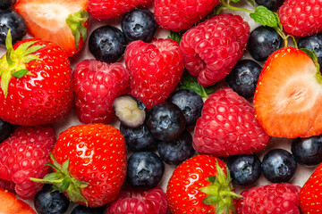 Fresh summer berries such as blueberries, strawberries, raspberries, top view
