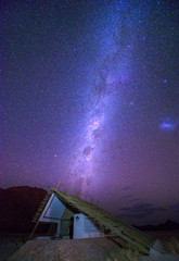 Milky way over a small chalet of a desert lodge near Sossusvlei in Namibia