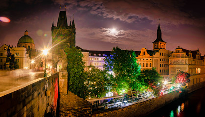 Fototapeta na wymiar Surounding areas of old Charles bridge in Prague at night in full moon