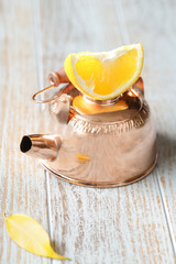 objects: teapot with a slice of lemon