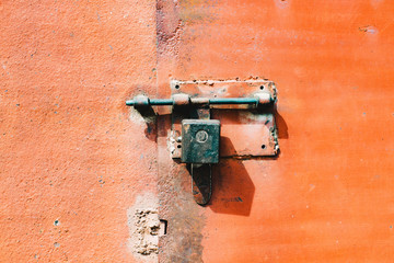  iron, orange rusty metal door with lock and shutter