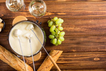 Cheese fondue with bread wine and grape