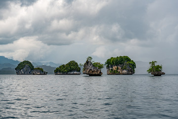 Fototapeta na wymiar Waigeo, Kri, Mushroom Island, group of small islands in shallow blue lagoon water, Raja Ampat, West Papua, Indonesia