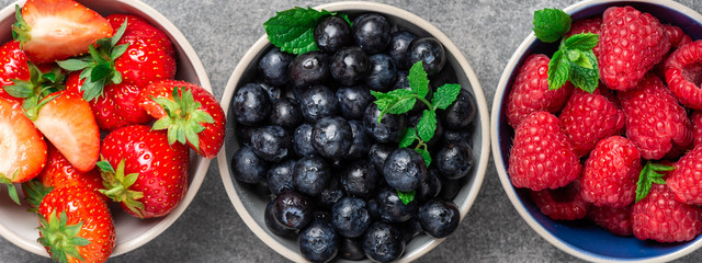 Fresh summer berries in the bowls. Blueberries, strawberries, raspberries shoot from the top © manuta