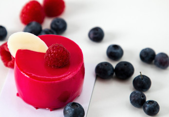 New beautiful stylish red cake with raspberries