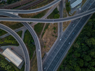 Road junction top view. Highways and forest. Traffic in the city. Aerial view