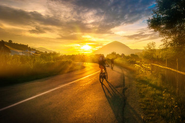 Road biking at sunrise healthy activity beautiful landscape