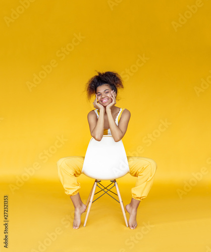 Smiling Young African Woman Wear Stylish Yellow Clothes Sit On