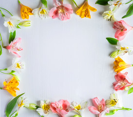 Mock up blank paper and envelope on blue wooden background with natural flowers of white color. Blank, frame for text. Greeting card design with flowers. Aalstroemeria on wooden background.