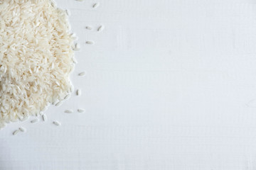 Frame for text with raw rice on a white wooden background. Banner with rice. Basis for a diet banner with rice