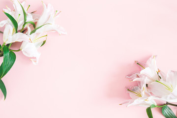 Flowers composition. Lily flowers on pastel pink background. Flat lay, top view, copy space