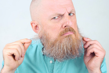 portrait of a bearded man on a light background