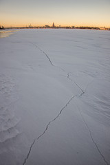pieces of frozen ice in the lake in dim winter day