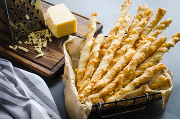 Cheese stick. Breadsticks with cheese on dark background. Concept for snack or party time