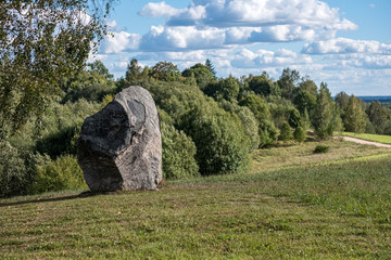 large rock in sand in countryside