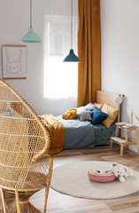 Stylish blue and orange kid's bedroom design in bright apartment