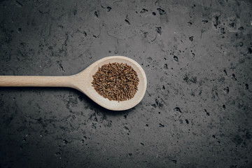 Cumin on a stone table. The concept of using seasonings for dishes. Strengthening the taste through spices, better cooking and better taste of dishes.