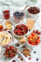 Summer berries strawberries, blueberries, sweet cherries in vases on the table. Top view