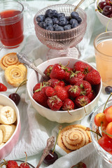 Summer berries strawberries, blueberries, sweet cherries in vases on the table. Top view