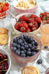 Summer berries strawberries, blueberries, sweet cherries in vases on the table. Top view