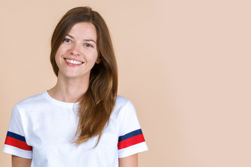 Portrait of adult girl looking at camera and smiling