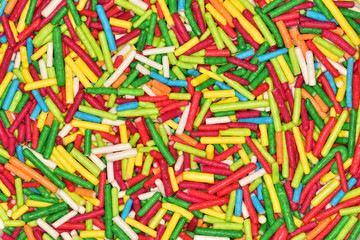 Abstract background of a variety of colorful sweet sticks used to decorate confectionery.