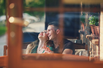 Pair laugh in a cafe