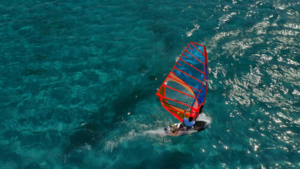 Fototapeta na wymiar Aerial photo of surfer cruising in high speed in Mediterranean destination bay with deep blue sea