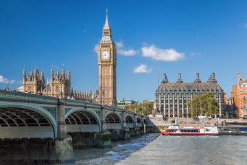 Fototapeta na wymiar Big Ben and Houses of Parliament with boat in London, England, UK