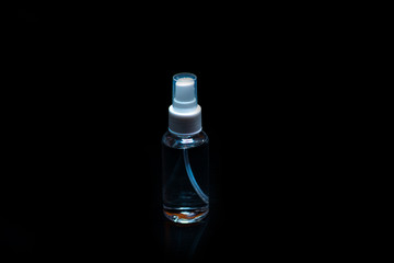 Glass cosmetic bottle isolated on black. Branding mock up.