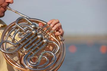 French horn instrument. Player hands playing horn music brass instrument