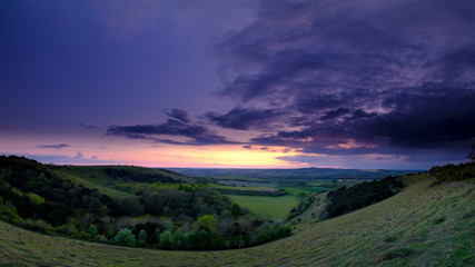 Fototapeta premium Summer sunset over Meon Valley towards Beacon Hill and Old Winchester Hill, South Downs National Park