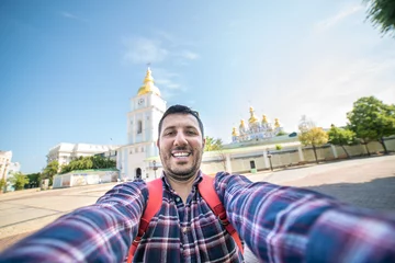 Fotobehang happy tourist take selfie photo in Kiev, Ukraine in a sunny summer day © photomaticstudio