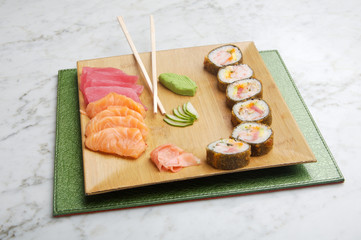 dish with sushi roles on marble table